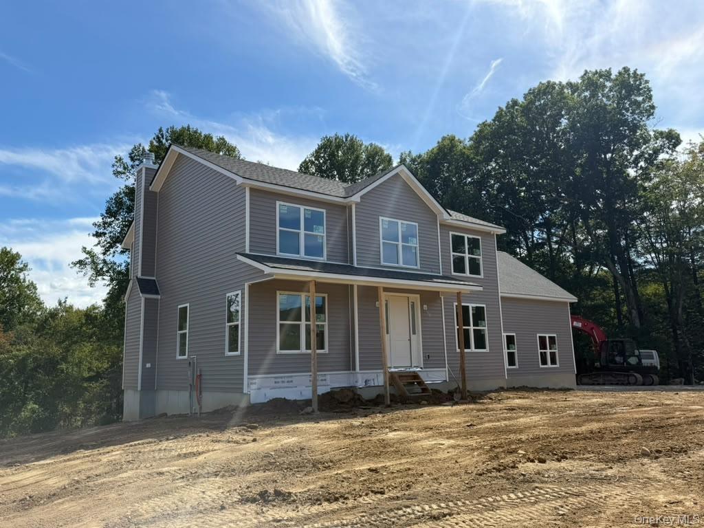 Two-story residence featuring gray siding, a covered porch, and white-framed windows