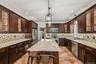 Kitchen with 7 foot 7 inch center island that seats 6, Anderson casement window above sink, Cafe appliances, granite countertops, tile backsplash, upl