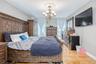 Master bedroom hardwood flooring, recessed lighting, ceiling medallion, and a multi-arm chandelier
