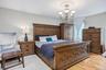 Hardwood flooring, ceiling medallion, chandelier, and a window with white drapes