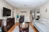 Recessed lighting illuminates wood-finish flooring