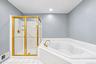 Primary bathroom with shower stall and large tub