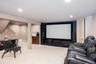 Entertainment area featuring a large projection screen, recessed lighting, and carpet flooring