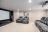 Media room featuring a large projection screen, projector, and recessed ceiling lighting