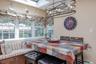 Built-in window seating with storage, multiple windows, skylight, and an overhead multi-light fixture
