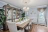 Formal Dining Room with hardwood flooring throughout, featuring crown molding, a decorative ceiling medallion, and an elaborate chandelier
