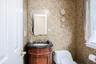 Half Bathroom ornate vanity with dark countertop, undermount sink, and decorative faucet