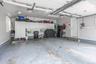 Attached garage featuring built-in cabinetry, overhead lighting, and a service door