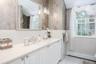 Dual-basin vanity with ample counter space, integrated sink, and white cabinetry