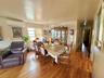Hardwood flooring throughout, with a crystal chandelier and prominent window