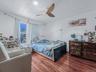 Bedroom with wood finished floors and ceiling fan