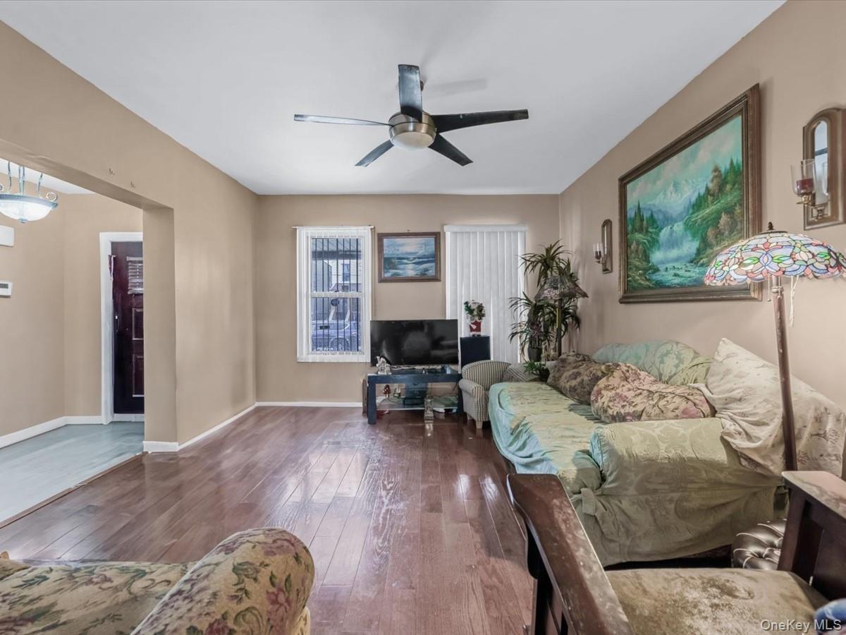 Living room featuring hardwood / wood-style floors and ceiling fan