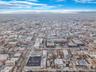 Aerial view of property and surrounding area with nearby urban area