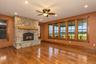 Stone-clad fireplace with a wood mantel and hearth