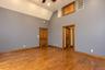 Hardwood flooring, vaulted ceiling, recessed lighting, wood-paneled doors, wood trim