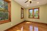 Hardwood flooring, wood-trimmed windows, recessed lighting, and a ceiling fan