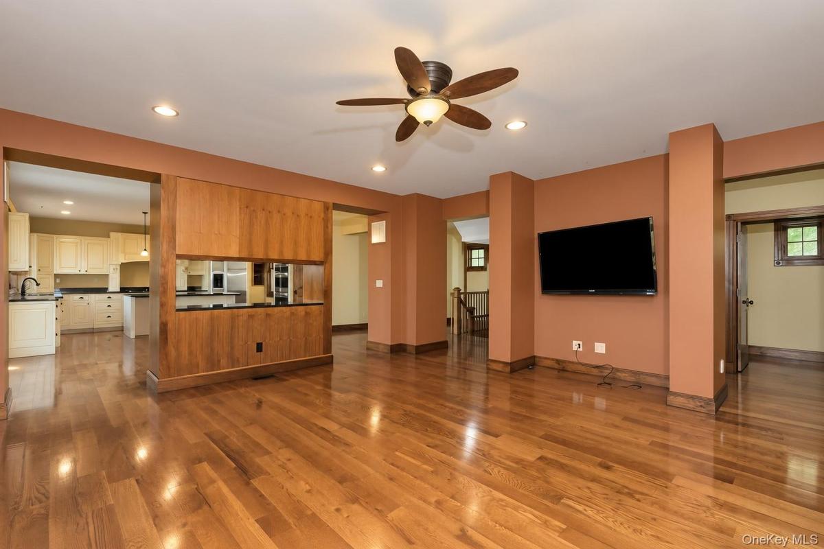 Hardwood flooring, recessed lighting, and a ceiling fan with integrated lighting