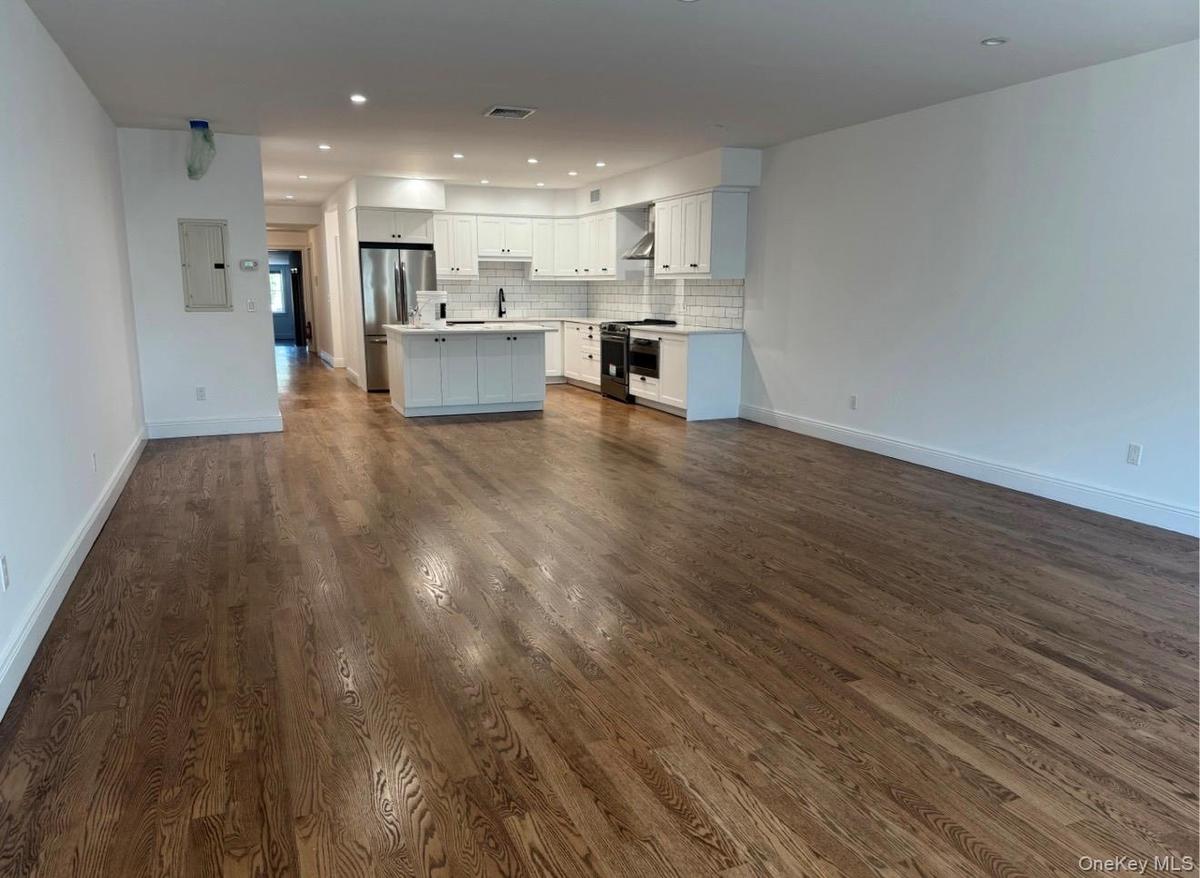 Unstated great room from front windows towards kitchen