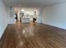 Unstated great room from front windows towards kitchen
