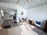 Vaulted corrugated metal ceiling complemented by wood-finish flooring