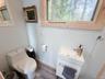 Compact vanity with an integrated basin and a brushed nickel faucet
