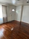 Foyer entrance with dark wood-style flooring and baseboards
