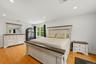 15x19 Primary Bedroom with recessed lighting, wide oak flooring and balcony access.