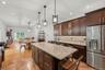 Kitchen with 7 foot 7 inch center island that seats 6, Cafe appliances, granite countertops, tile backsplash, uplighting, Recessed lighting, marble ti