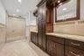 Primary bathroom with granite vanities, marble tile oversized shower with rainfall shower head. WIC access in primary bath.