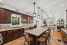Kitchen with 7 foot 7 inch center island that seats 6, Anderson casement window above sink, Cafe appliances, granite countertops, tile backsplash, upl