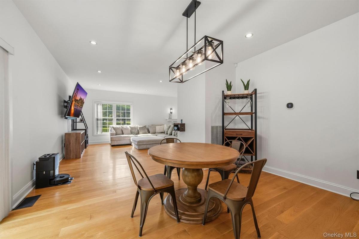 Dining room, with Anderson slider, that leads to a stamped concrete patio. Recessed lighting, wide plank white oak flooring and 9 foot ceilings.