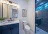 Full bathroom accessible off of the kitchen hallway, and the outdoor patio
