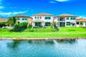 Expansive green lawn with water frontage and mature trees