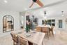 Open-concept interior featuring recessed lighting, a modern ceiling fan, and light-toned flooring