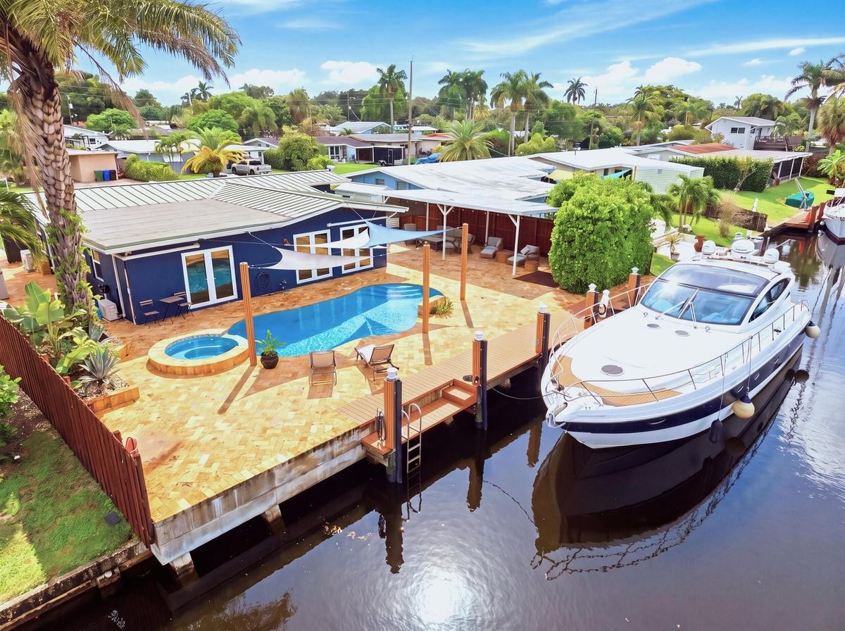 Waterfront property featuring a private dock, swimming pool, and integrated spa