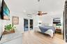 Light wood-finish flooring, ceiling fan with wood blades, recessed lighting, and white walls