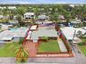 Aerial perspective highlighting the property's waterfront location, private boat dock, and surrounding canal