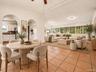 Virtually staged: living and dining area with arched entry to the kitchen