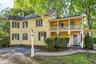 Side exterior showcasing the home’s distinctive architecture and two-level covered porches.