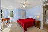Spacious bedroom with multiple windows, abundant natural light, and a bright sitting area.
