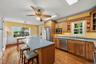 Bright kitchen with center island, stainless steel appliances and breakfast area