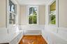 Bright reading nook surrounded by windows and built-in bench seating