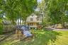 Charming exterior surrounded by mature trees and a spacious yard