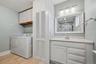 Full bathroom with convenient laundry area
