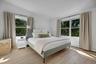 Spacious bright primary suite with seasonal views of bridge...