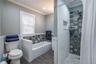 Spacious bathroom with separate tub and shower stall.