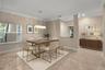 Virtual staging. Large dining area with full impact windows and abundant light