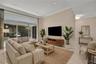 Virtual staging. Full impact doors opening to serene patio views