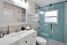 Updated bathroom with new vanity and fixtures, and glass-enclosed shower