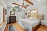 The oversized primary bedroom features custom windows, cathedral ceilings and is large enough for a king size bed.